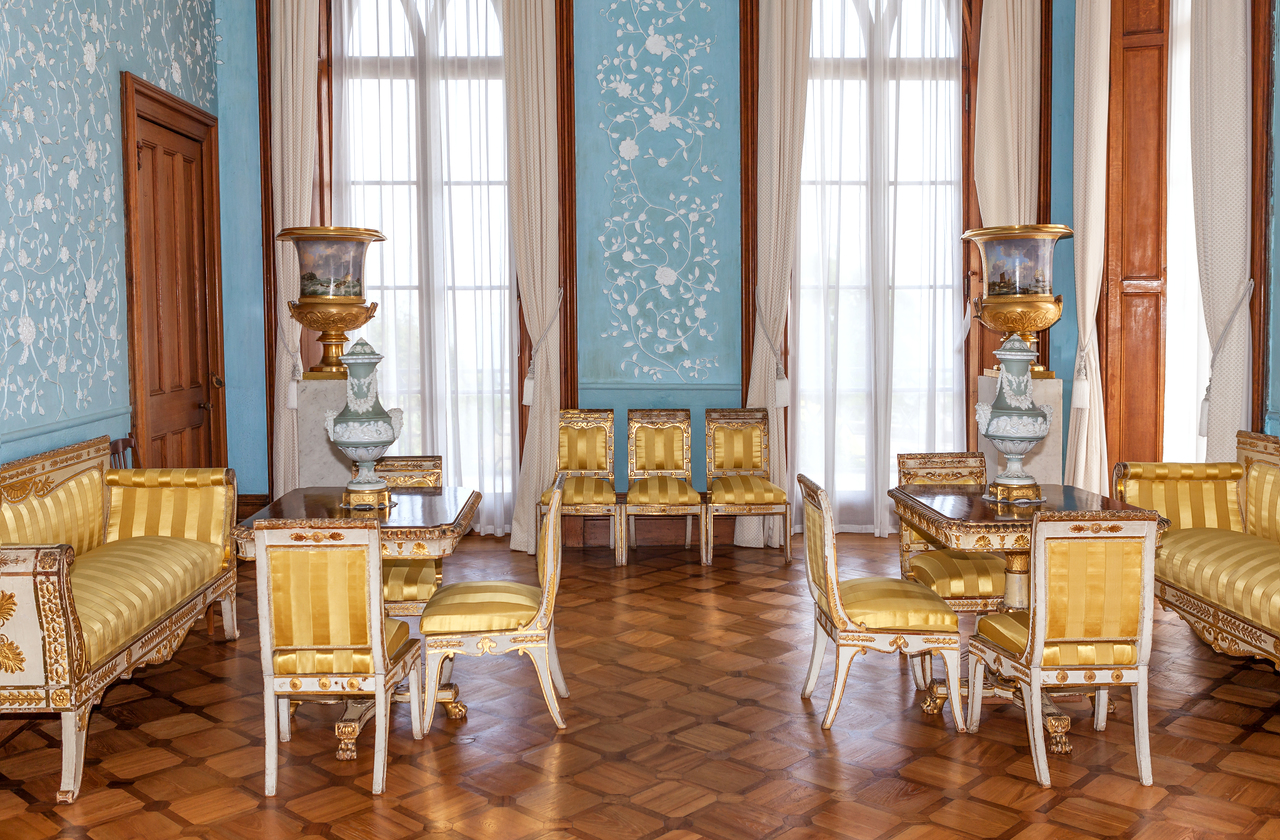 A living room adorned with gold embroidered chairs