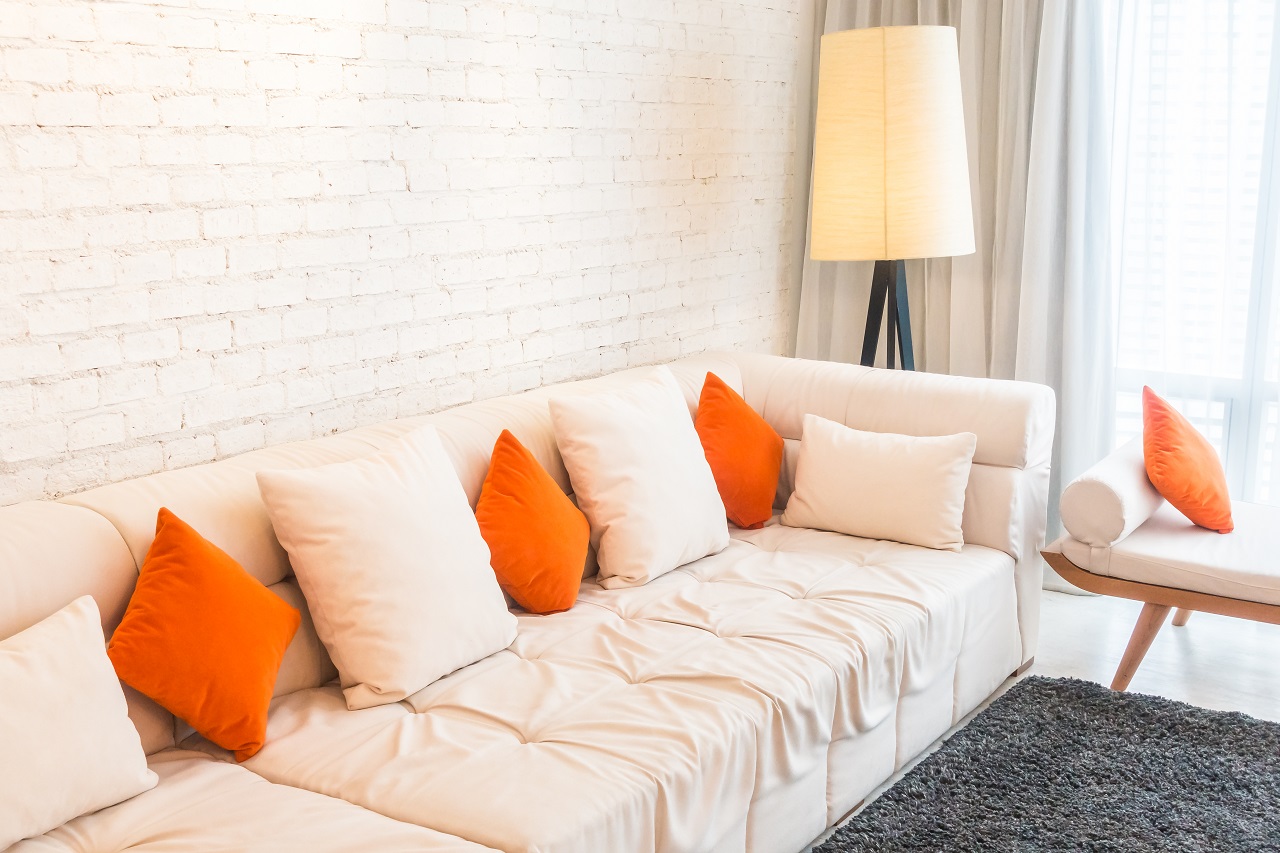 Orange pillows on a white sofa